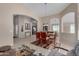 Bright dining room with a glass-top table and wooden chairs at 1435 E Debbie Dr, San Tan Valley, AZ 85140
