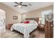 Bright bedroom with a queen bed, ensuite bathroom access, and wood furniture at 1435 E Debbie Dr, San Tan Valley, AZ 85140
