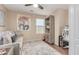 Home office with a sofa, shelving unit and a work desk at 1435 E Debbie Dr, San Tan Valley, AZ 85140