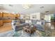 Comfortable living room with a gray sofa, wooden floors, recessed lighting, and an open layout to the kitchen at 1440 E Secretariat Dr, Tempe, AZ 85284