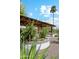 Outdoor kitchen and dining area with desert landscaping, featuring lush greenery and a decorative tiled retaining wall at 1440 E Secretariat Dr, Tempe, AZ 85284