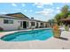 Inviting backyard pool with a tile border, surrounded by a patio, lush landscaping, and an outdoor entertaining area at 1440 E Secretariat Dr, Tempe, AZ 85284