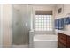 Bathroom with a shower and tub, updated vanity, and large window at 15250 S 29Th St, Phoenix, AZ 85048