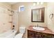 Cozy bathroom with combined shower-tub, decorative tiles, unique vanity, and warm lighting at 16149 E Thistle Dr, Fountain Hills, AZ 85268