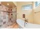 Elegant bathroom featuring a clawfoot tub and glass shower, designed with classic fixtures at 16149 E Thistle Dr, Fountain Hills, AZ 85268