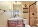 Stylish bathroom features decorative vanity, a unique mirror, and a tiled shower at 16149 E Thistle Dr, Fountain Hills, AZ 85268