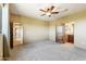 Generous bedroom area with neutral carpet, ceiling fan, and ensuite bathroom entrance at 16149 E Thistle Dr, Fountain Hills, AZ 85268