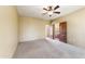 Bright bedroom featuring a ceiling fan, carpeted floor, and open doorway to an en suite bathroom at 16149 E Thistle Dr, Fountain Hills, AZ 85268