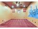 Unique bedroom with statement walls, ceiling fan, red carpet, and playful decor creating a fun and inviting space at 16149 E Thistle Dr, Fountain Hills, AZ 85268