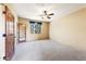 Spacious bedroom with carpeted floors, ceiling fan, and natural light from the window at 16149 E Thistle Dr, Fountain Hills, AZ 85268