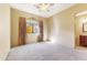 Neutral bedroom with large windows, light carpet, and traditional decor creating a peaceful retreat at 16149 E Thistle Dr, Fountain Hills, AZ 85268