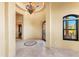Elegant foyer showcasing a decorative tile inlay, decorative light fixture and wrought iron door at 16149 E Thistle Dr, Fountain Hills, AZ 85268