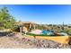 Exterior view of a home featuring a pool, patio, and desert landscape at 16149 E Thistle Dr, Fountain Hills, AZ 85268