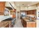 Fully-equipped kitchen with a gourmet gas range and stainless steel appliances and wood cabinets at 16149 E Thistle Dr, Fountain Hills, AZ 85268