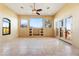 Spacious living room featuring travertine flooring, expansive windows and backyard views at 16149 E Thistle Dr, Fountain Hills, AZ 85268