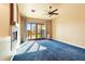 Spacious living room with fireplace, ceiling fan, and sliding glass doors leading to the backyard at 16149 E Thistle Dr, Fountain Hills, AZ 85268