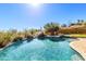 Inviting pool and spa featuring beautiful tile work and desert landscaping at 16149 E Thistle Dr, Fountain Hills, AZ 85268