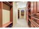 Large walk-in closet with custom wood shelving and drawers providing ample storage solutions at 16149 E Thistle Dr, Fountain Hills, AZ 85268