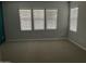 Well-lit bedroom featuring neutral walls and carpet at 1669 S Wallrade Ln, Gilbert, AZ 85295