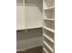 Spacious walk-in closet with built-in shelves and hanging rods at 1669 S Wallrade Ln, Gilbert, AZ 85295