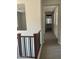 Upper level hallway with carpeted floors and access to bedrooms at 1669 S Wallrade Ln, Gilbert, AZ 85295