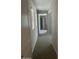 Long hallway with carpet and access to bedrooms at 1669 S Wallrade Ln, Gilbert, AZ 85295