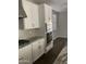 White kitchen cabinets, granite counters and stainless steel appliances at 1669 S Wallrade Ln, Gilbert, AZ 85295