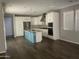Modern kitchen with white cabinets, granite island, and stainless steel appliances at 1669 S Wallrade Ln, Gilbert, AZ 85295