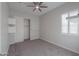 Bright bedroom with plush carpeting, window shutters, and built-in shelving at 18046 N Stonegate Rd, Maricopa, AZ 85138