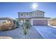 Two-story house with brown garage door and desert landscaping at 227 W Bobcat Ct, Casa Grande, AZ 85122