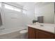 Updated bathroom with tub/shower, vanity, and mirror at 22814 W Cantilever St, Buckeye, AZ 85326