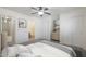 Well-lit bedroom with neutral tones, closet, ensuite bath, and ceiling fan at 22814 W Cantilever St, Buckeye, AZ 85326
