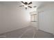 Bright bedroom with ceiling fan, window blinds, and double door closet at 22814 W Cantilever St, Buckeye, AZ 85326