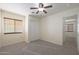 Spacious bedroom with ceiling fan, window blinds, and double door closet at 22814 W Cantilever St, Buckeye, AZ 85326