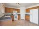 Galley kitchen with wood cabinets, tile floor, and appliances at 22814 W Cantilever St, Buckeye, AZ 85326