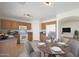 Bright kitchen featuring wood cabinets, white appliances, and a cozy dining area at 22814 W Cantilever St, Buckeye, AZ 85326