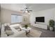 Inviting living room with tile floors, ceiling fan, and modern decor at 22814 W Cantilever St, Buckeye, AZ 85326