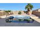 Octagon shaped pool with surrounding landscaping and patio at 22814 W Cantilever St, Buckeye, AZ 85326