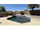 Backyard pool featuring tiled trim, stone landscaping, privacy wall and mature palm trees under a clear blue sky at 22814 W Cantilever St, Buckeye, AZ 85326