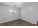 Spacious bedroom with a window and wood-look flooring at 2440 W Bloch Rd, Phoenix, AZ 85041