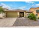 Front view of a single-story house with a green garage door at 2440 W Bloch Rd, Phoenix, AZ 85041