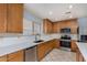 Modern kitchen with stainless steel appliances and light wood cabinets at 2440 W Bloch Rd, Phoenix, AZ 85041