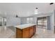 Open kitchen with island, stainless steel appliances, and light wood cabinets at 2440 W Bloch Rd, Phoenix, AZ 85041