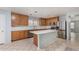 Spacious kitchen with island, stainless steel appliances, and light wood cabinets at 2440 W Bloch Rd, Phoenix, AZ 85041