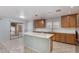 Modern kitchen with island, stainless steel appliances, and light wood cabinets at 2440 W Bloch Rd, Phoenix, AZ 85041