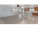 Open concept kitchen and living area with wood-look floors and island at 2440 W Bloch Rd, Phoenix, AZ 85041