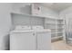 Laundry room with washer, dryer, and shelving at 2440 W Bloch Rd, Phoenix, AZ 85041