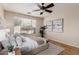 Bedroom with hardwood floors, large window, and neutral tones at 2475 N 163Rd Dr, Goodyear, AZ 85395