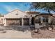 Two-story house with brown garage doors and a landscaped front yard at 2475 N 163Rd Dr, Goodyear, AZ 85395