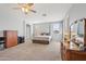 Large main bedroom with carpeted floor and ceiling fan at 26210 N 69Th Ln, Peoria, AZ 85383